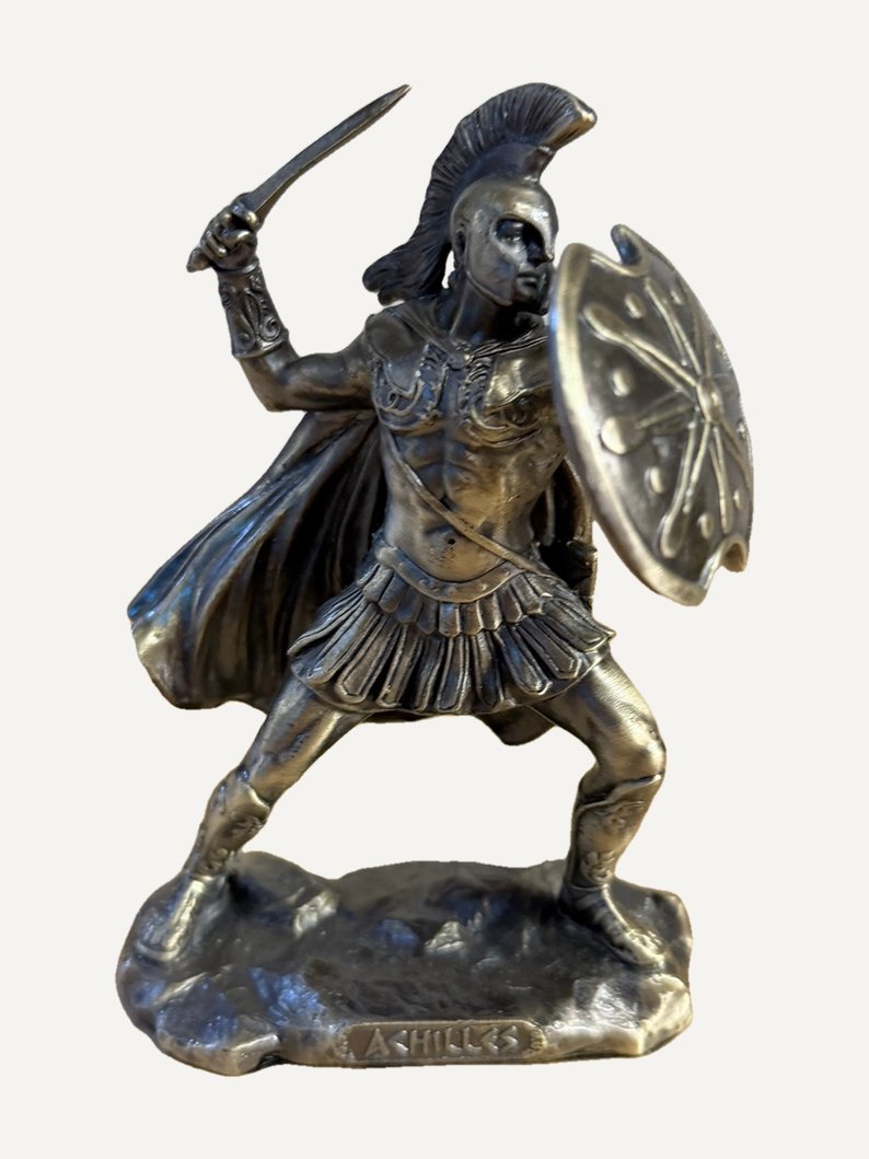 Achilles pewter figurine: crested helmet, sword raised in his right hand, notched shield on his left arm, cloak and pleated kilt, ACHILLES on the base