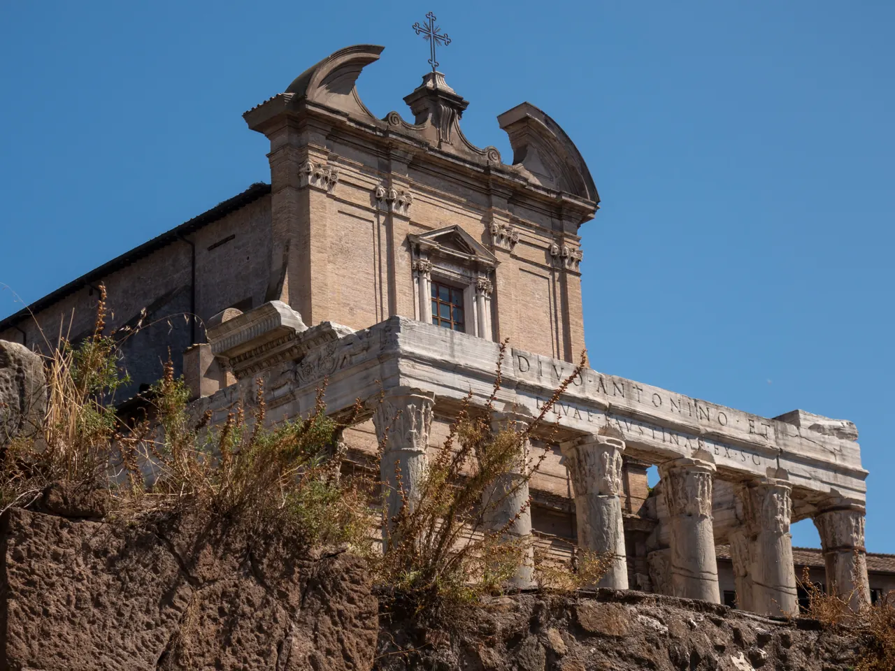 The architrave of the Temple of Antoninus and Faustina with the two lines of the ancient inscription, seen from below.